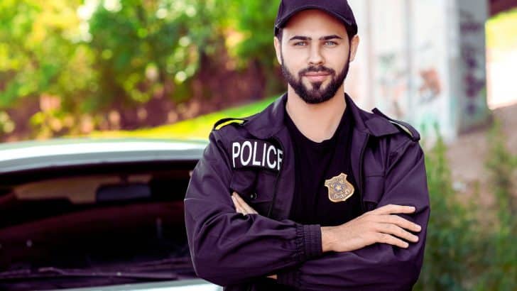 Une personne se tient devant un commissariat de police, hésitant à déposer une plainte pour attouchements sans preuve.